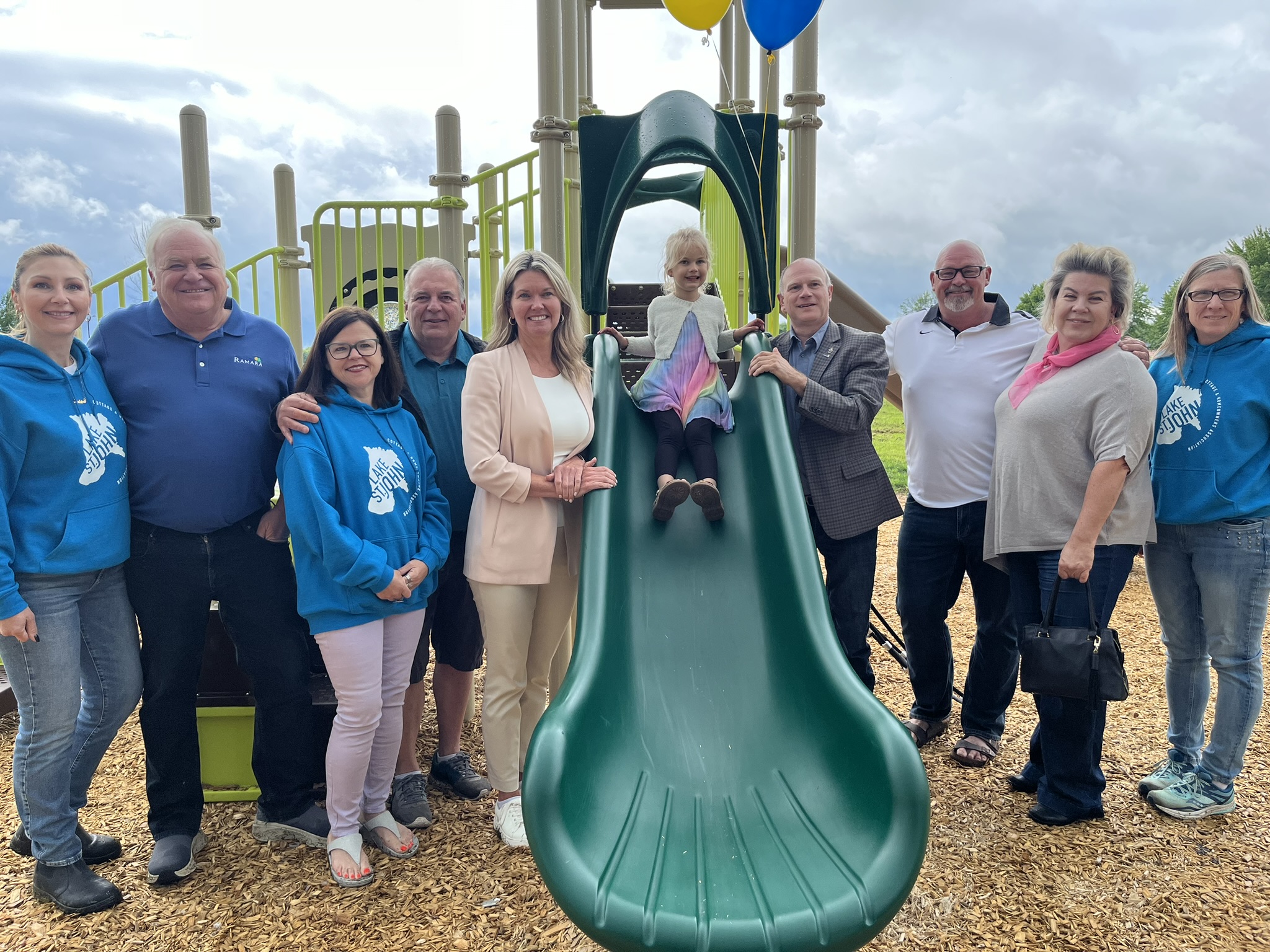 A picture of representatives who attended the Bluebird Playground Grand Opening.