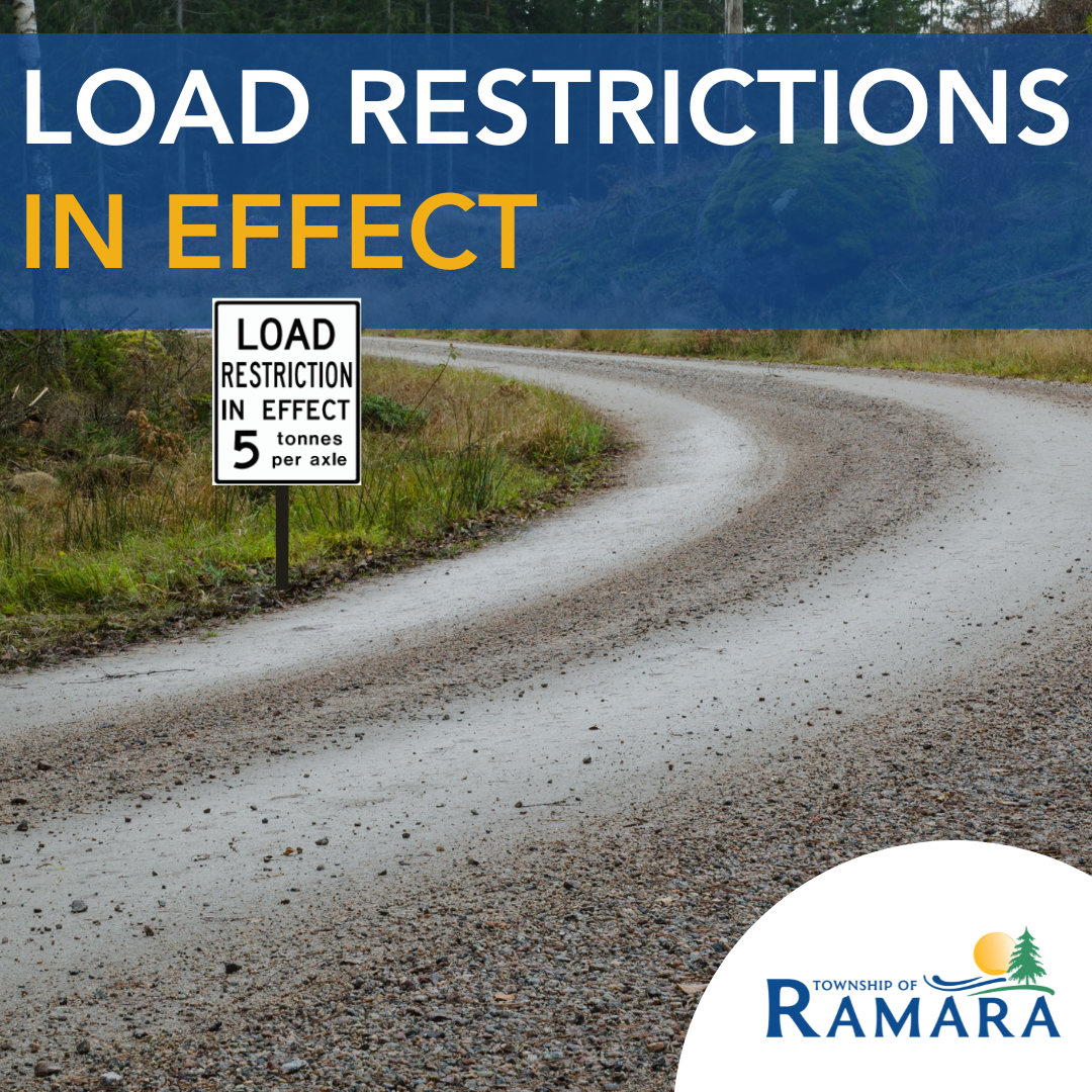 Picture of a road with a load restriction sign stating restrictions are in effect.