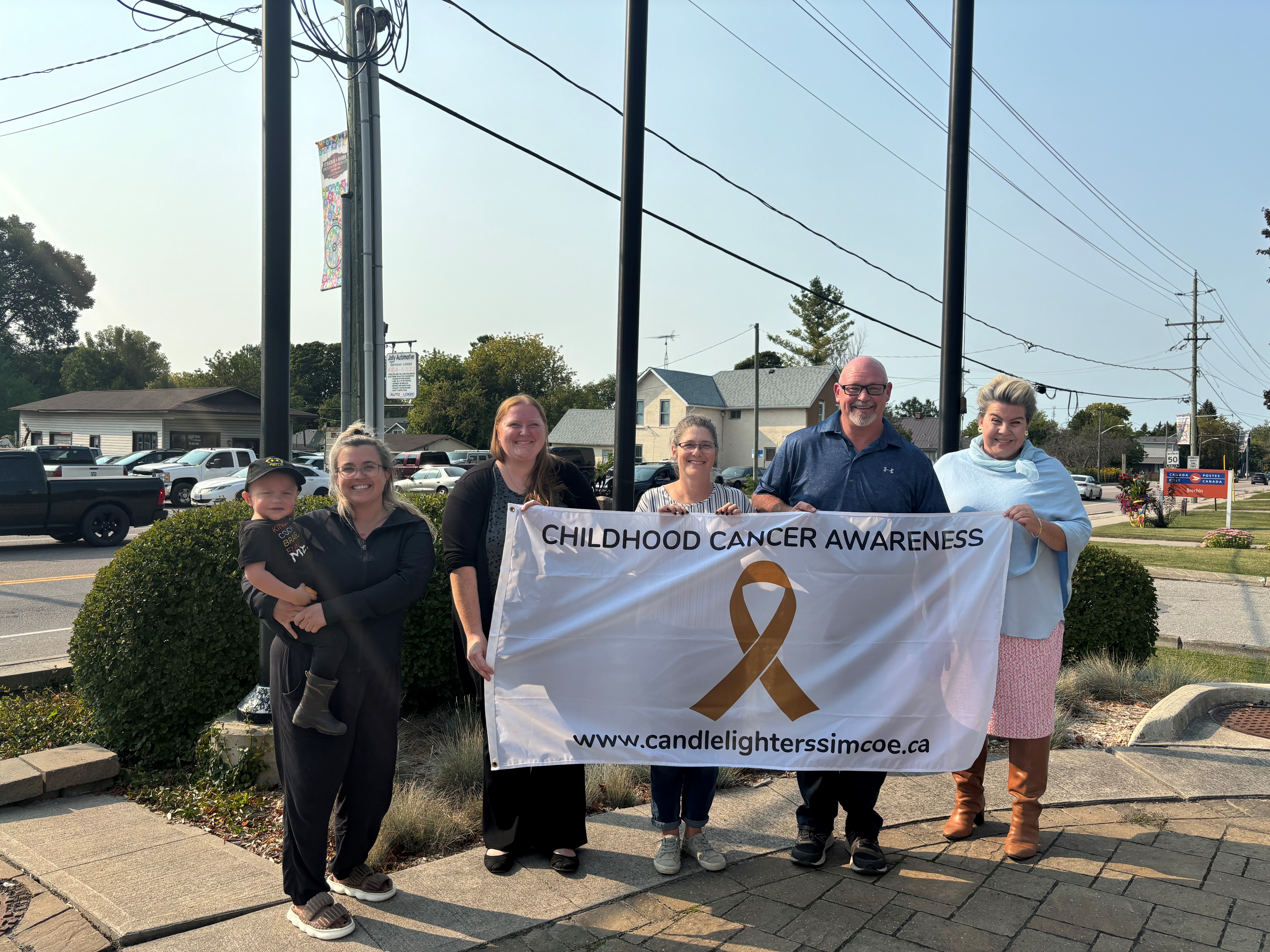 Picture of flag raising for Childhood Cancer Awareness month