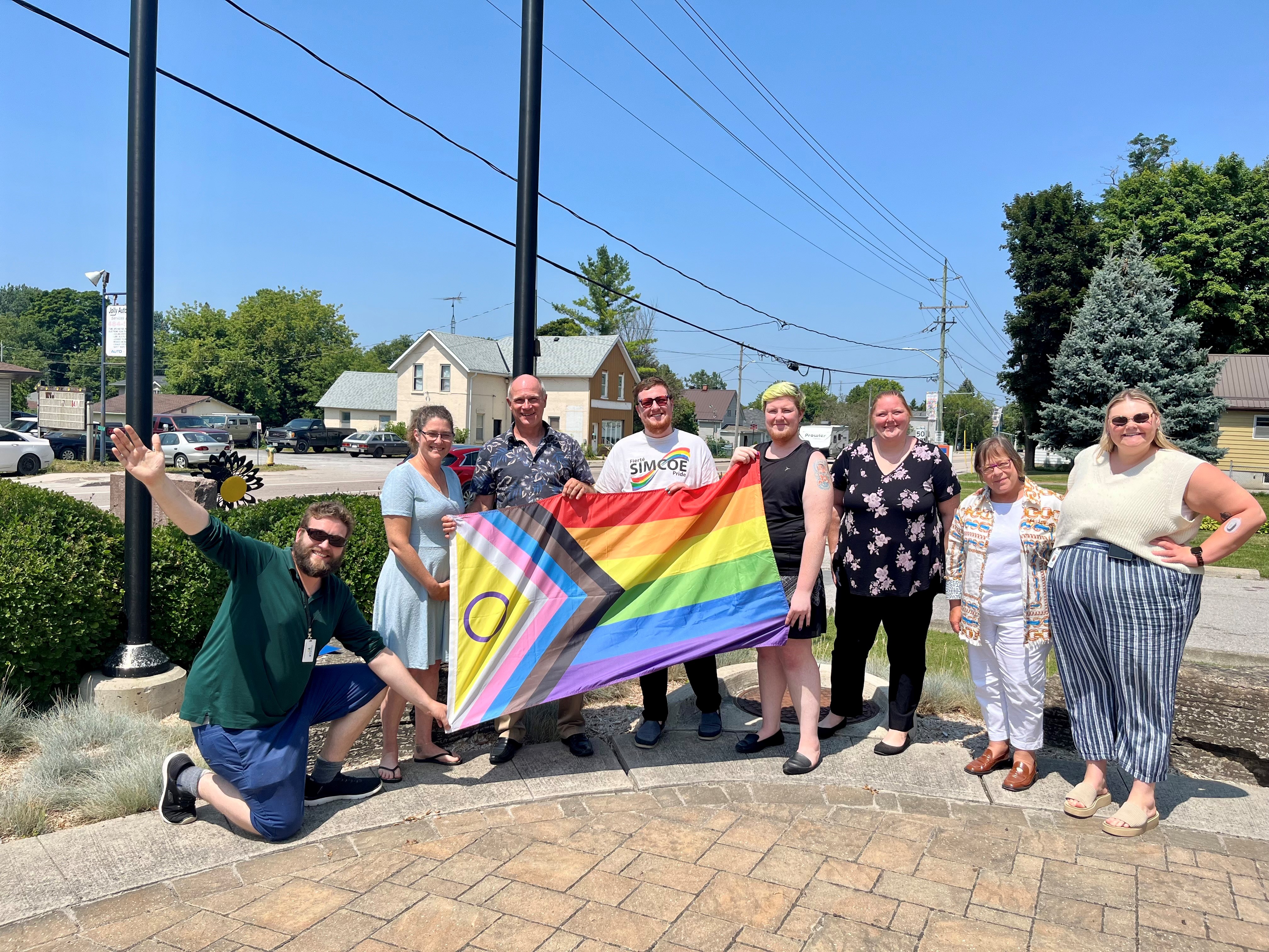 Picture of staff, FSP reps and members of Council holding the Intersex-Inclusive Progress Pride Flag