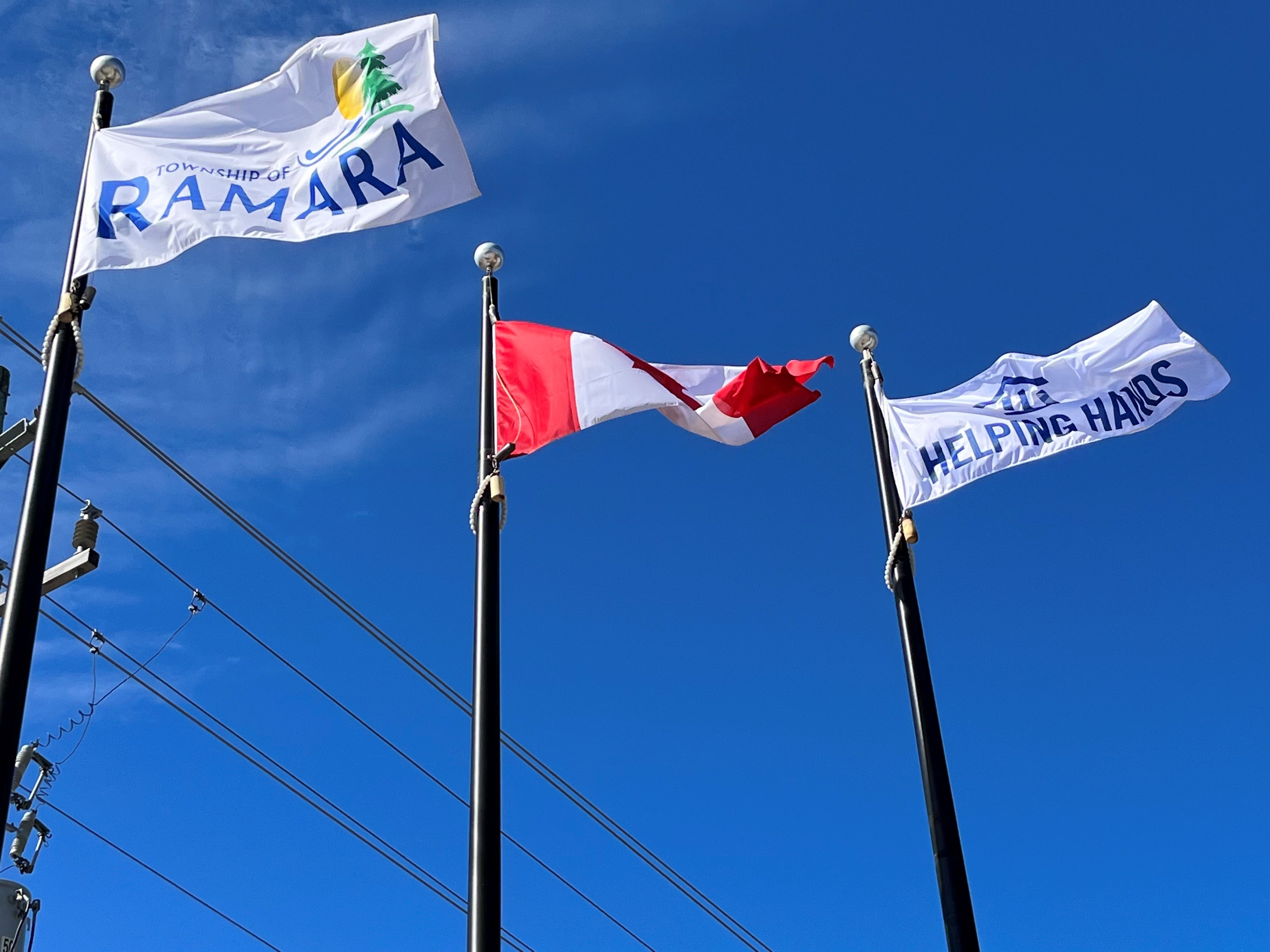 A picture of the Township of Ramara, Canada Day and Helping Hand flags