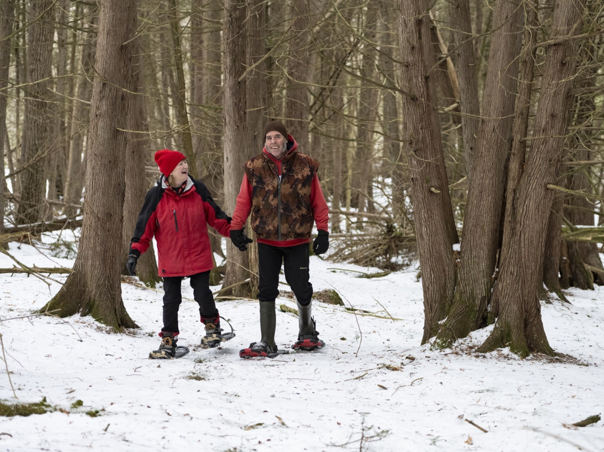 A picture of two adults snowshoeing